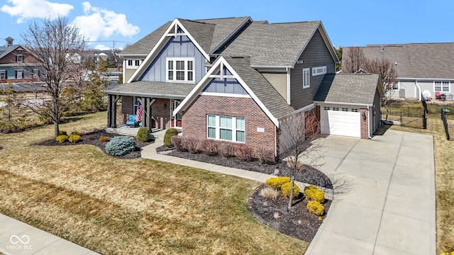 view of front of house with brick siding, board and batten siding, a porch, concrete driveway, and a front yard