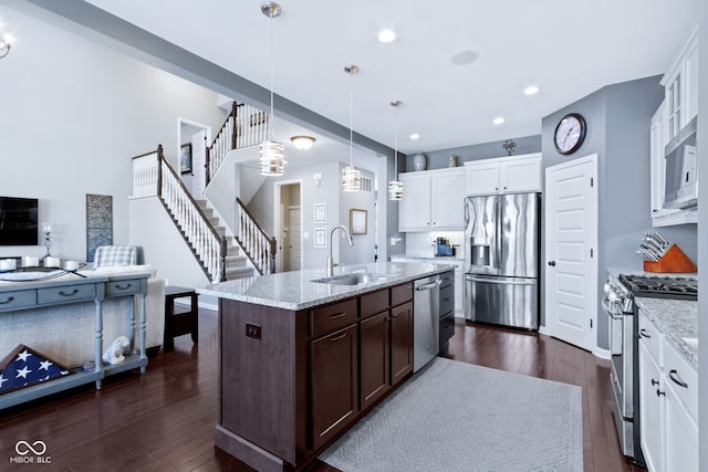 kitchen featuring a sink, dark wood-type flooring, dark brown cabinets, and stainless steel appliances