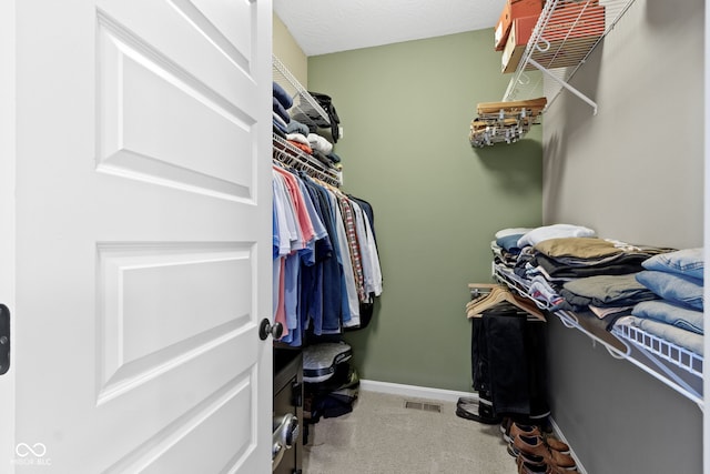 spacious closet featuring visible vents and carpet