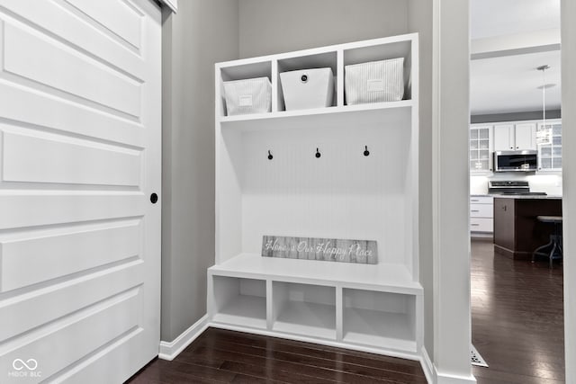 mudroom with baseboards and dark wood-style flooring