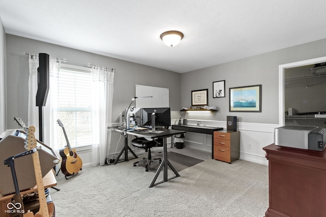 office featuring baseboards and light carpet