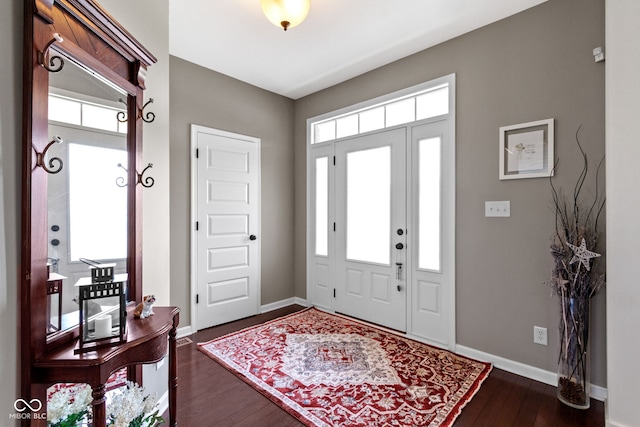 entryway featuring dark wood finished floors and baseboards