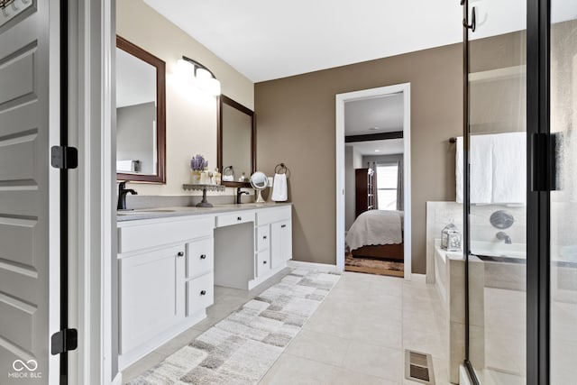 ensuite bathroom with double vanity, visible vents, a shower stall, and a sink