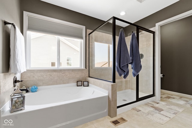 bathroom with a bath, visible vents, a shower stall, and tile patterned floors