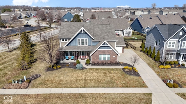 view of front of home featuring board and batten siding, a front lawn, a residential view, concrete driveway, and covered porch