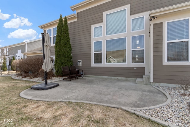 rear view of property featuring a patio area and fence