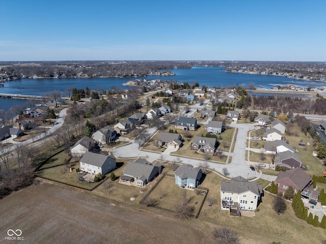 drone / aerial view with a residential view and a water view