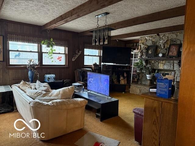 carpeted living area with a textured ceiling, beamed ceiling, and wooden walls