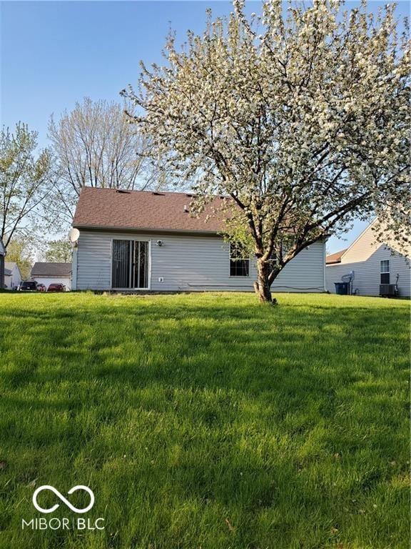 rear view of house with a yard