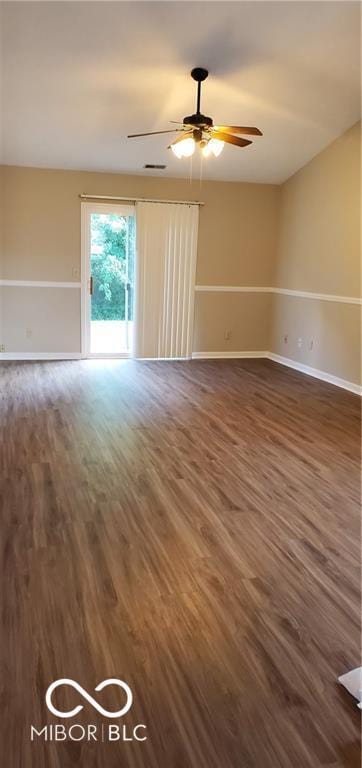 empty room featuring ceiling fan, wood finished floors, and baseboards