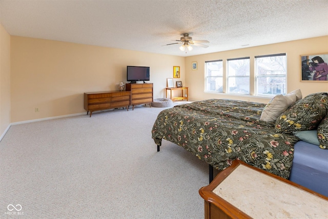 bedroom featuring baseboards, carpet floors, a textured ceiling, and a ceiling fan