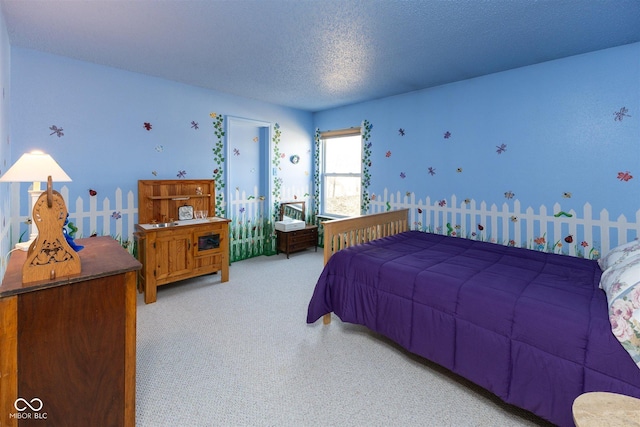 bedroom with a textured ceiling and carpet