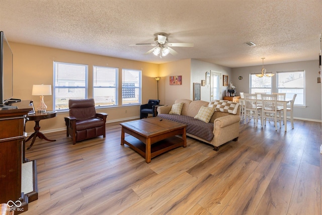 living area featuring visible vents, plenty of natural light, and light wood finished floors