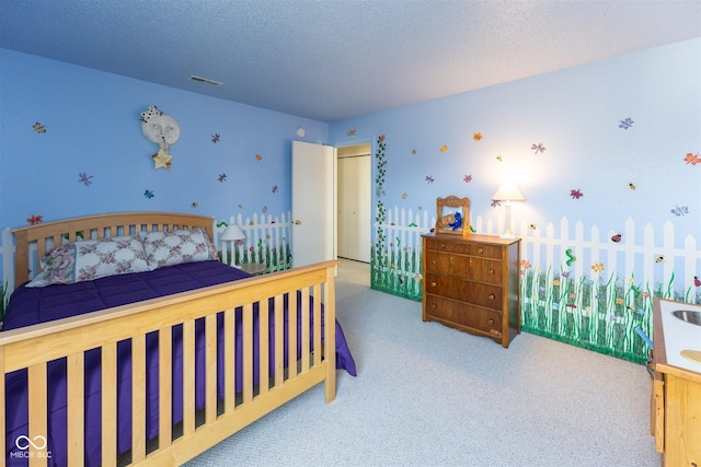 carpeted bedroom with visible vents and a textured ceiling