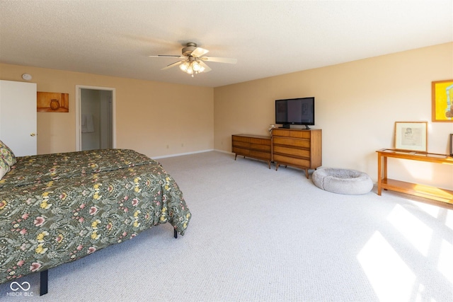 bedroom with carpet flooring, a ceiling fan, baseboards, and a textured ceiling