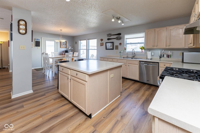 kitchen with a sink, light countertops, light brown cabinetry, and stainless steel appliances