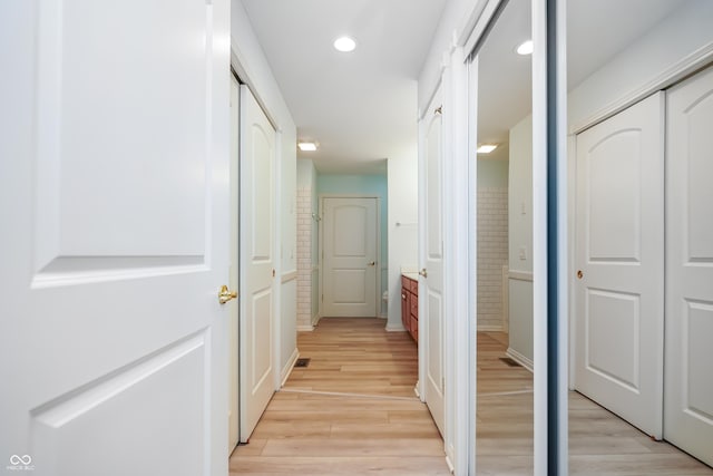 hallway with recessed lighting and light wood-style flooring