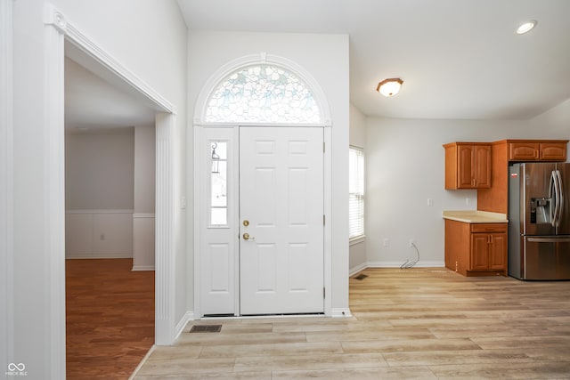 entryway with light wood-type flooring and visible vents