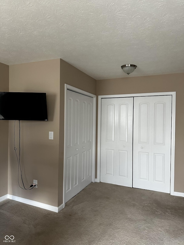 14309 Shooting Star Dr, Noblesville, IN 46060 - unfurnished bedroom featuring carpet flooring, a textured ceiling, and two closets