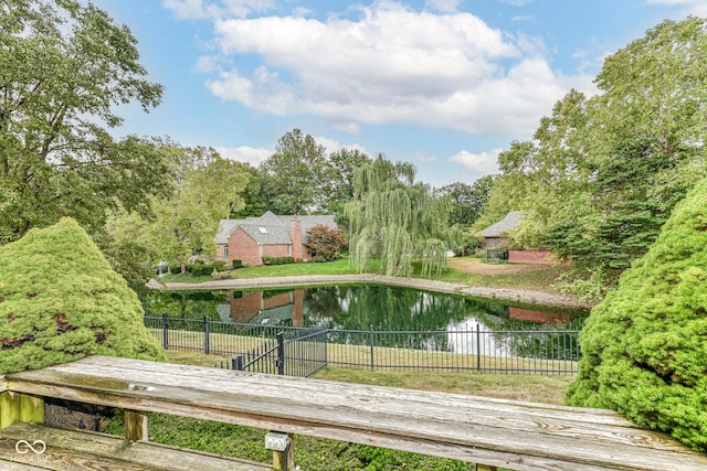 surrounding community featuring a water view and fence