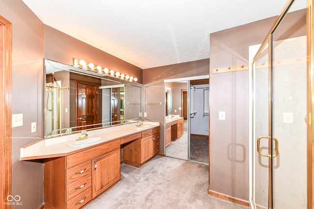 full bath featuring a textured ceiling, a stall shower, and vanity