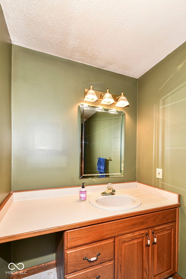 bathroom with a textured ceiling and vanity