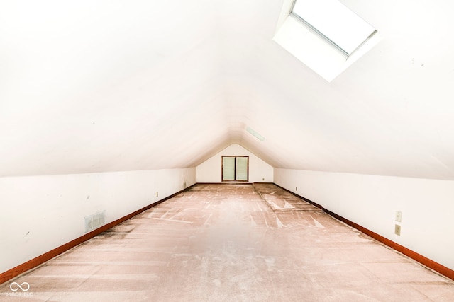 additional living space with lofted ceiling, carpet floors, visible vents, and baseboards