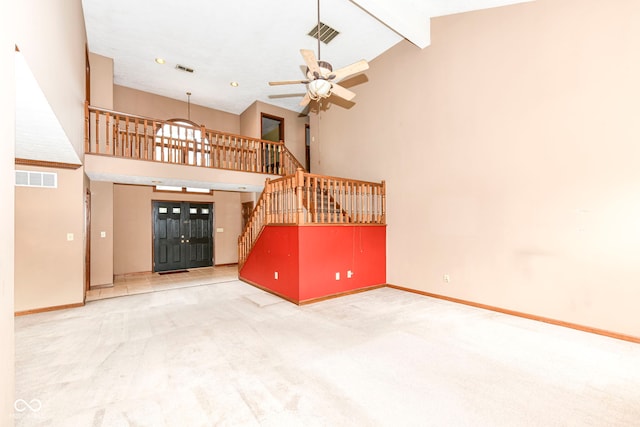 unfurnished living room with high vaulted ceiling, visible vents, stairs, beam ceiling, and carpet