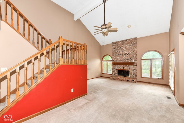 unfurnished living room with carpet floors, a fireplace, high vaulted ceiling, beamed ceiling, and baseboards