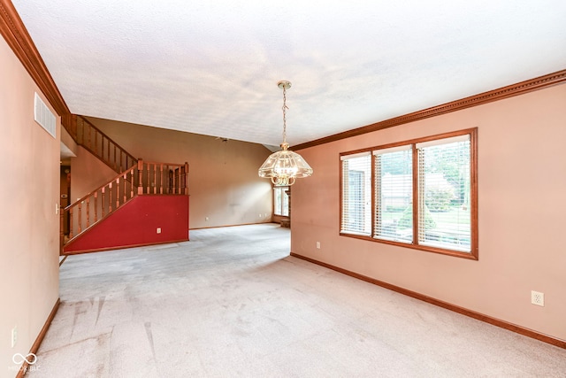 unfurnished room with visible vents, baseboards, stairway, an inviting chandelier, and carpet flooring