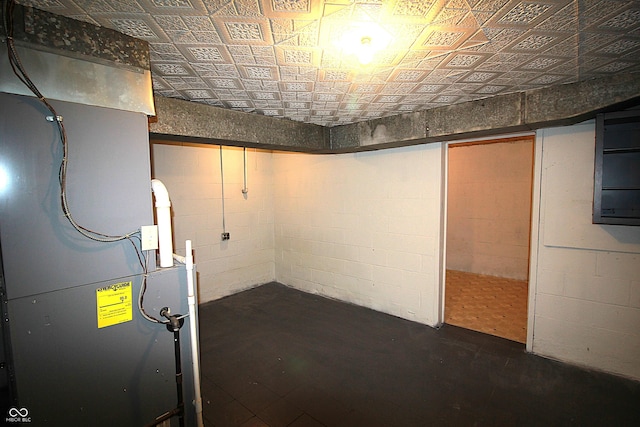 unfinished below grade area with an ornate ceiling and concrete block wall