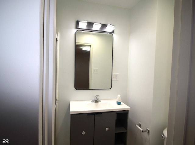 bathroom with toilet and vanity