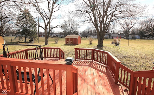 deck featuring a storage shed, a yard, and an outdoor structure