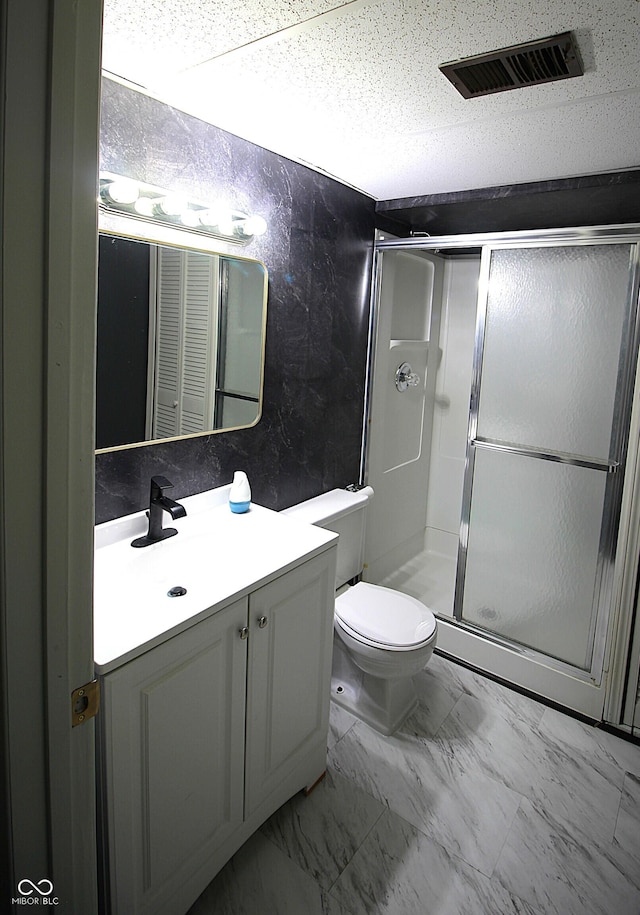 full bathroom with marble finish floor, visible vents, toilet, a stall shower, and vanity