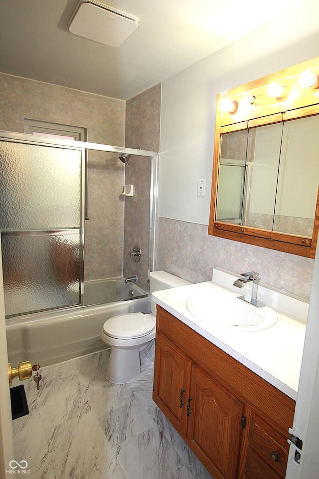 full bath with toilet, marble finish floor, shower / bath combination with glass door, and vanity