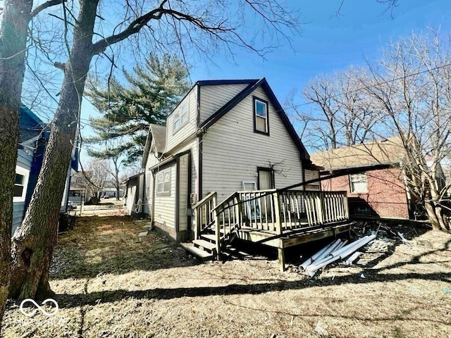 view of property exterior with a wooden deck