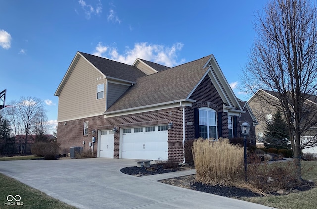 view of side of property with central air condition unit, brick siding, roof with shingles, and driveway