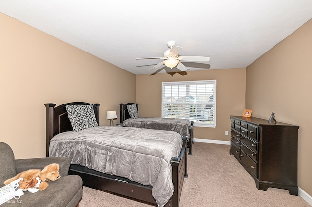 bedroom featuring ceiling fan, baseboards, and light carpet