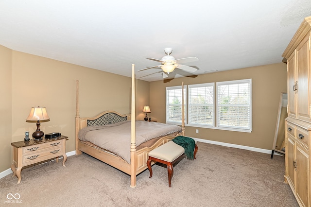 bedroom with visible vents, light colored carpet, a ceiling fan, and baseboards