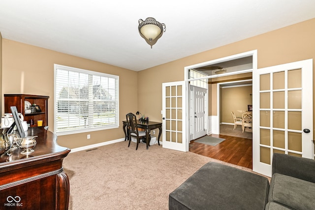 office space featuring carpet flooring, french doors, and baseboards