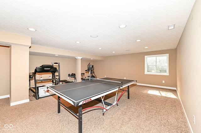 rec room featuring recessed lighting, baseboards, light colored carpet, and a textured ceiling