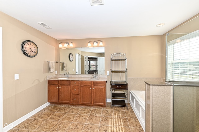 full bath featuring double vanity, visible vents, a bath, and a sink