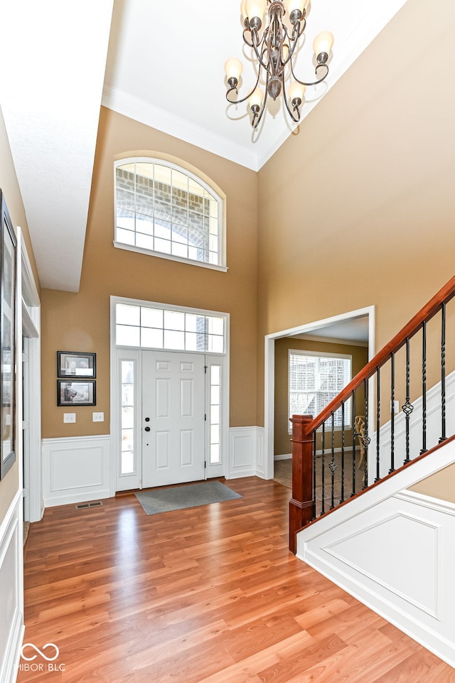 entrance foyer featuring plenty of natural light, stairs, and light wood finished floors