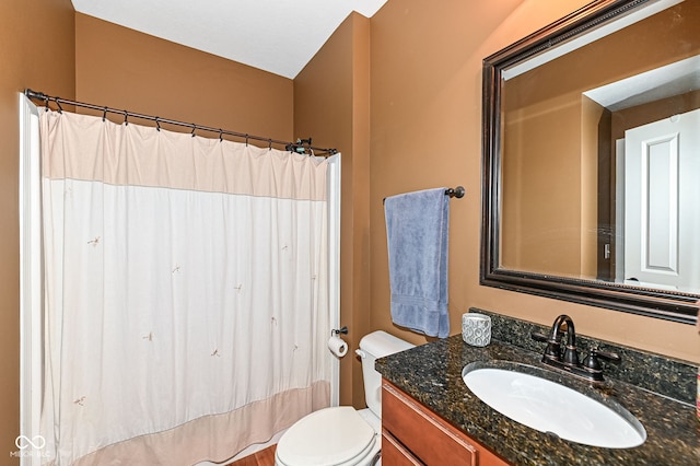 bathroom with vanity, curtained shower, and toilet