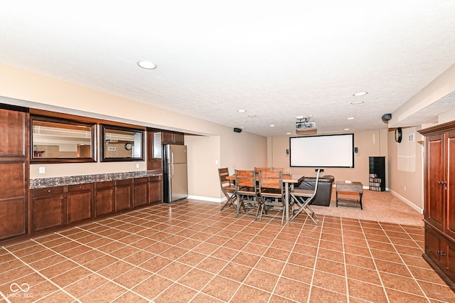 dining area featuring light tile patterned floors, recessed lighting, a textured ceiling, and baseboards