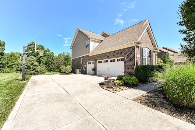 14034 Wicklow Ln, Fishers, IN 46040 - view of property exterior with brick siding, an attached garage, driveway, and roof with shingles