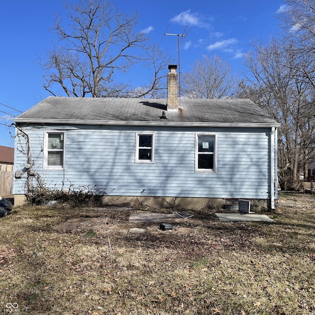 view of side of home featuring a chimney