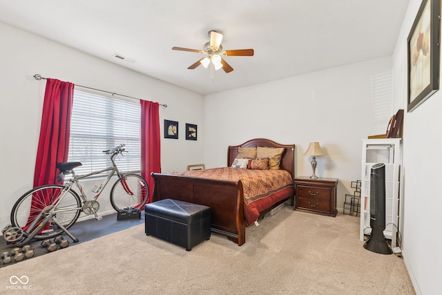 carpeted bedroom featuring baseboards, visible vents, and a ceiling fan