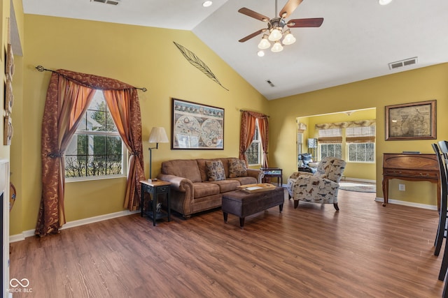 living area with visible vents, ceiling fan, baseboards, and wood finished floors