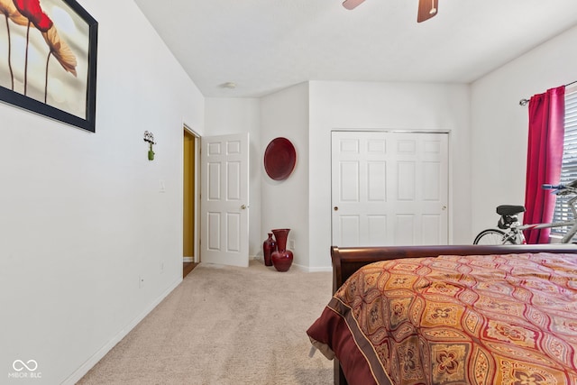 carpeted bedroom with a ceiling fan and baseboards